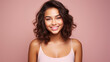 © ALA - Portrait of smiling latin american teenage girl with pink background.