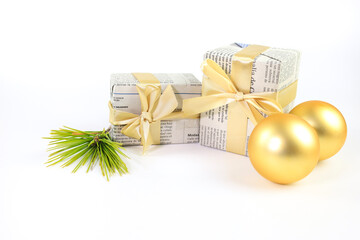 Gifts wrapped in old newspaper on white background