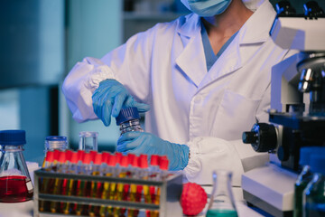 Wall Mural - scientist mixing chemical liquids in the chemistry lab. researcher working in the chemical laborator