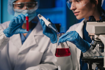 Wall Mural - team scientist mixing chemical liquids in the chemistry lab. researcher working in the chemical labo