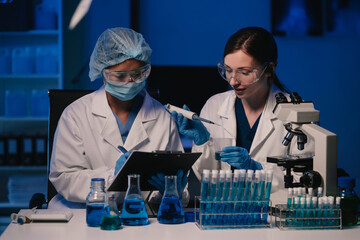 Wall Mural - team scientist mixing chemical liquids in the chemistry lab. researcher working in the chemical labo