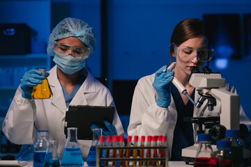 Wall Mural - team scientist mixing chemical liquids in the chemistry lab. researcher working in the chemical labo