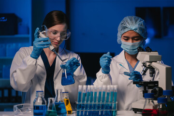 Wall Mural - team scientist mixing chemical liquids in the chemistry lab. researcher working in the chemical labo