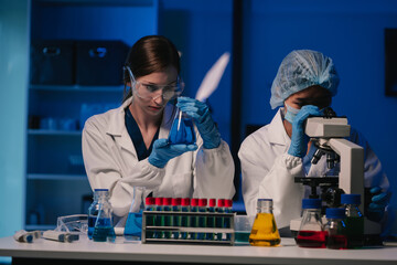 Wall Mural - team scientist mixing chemical liquids in the chemistry lab. researcher working in the chemical labo