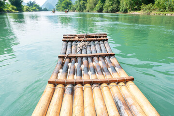 a bamboo raft paddling on the river