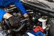 © zphoto83 - A mechanic performing repair work on a car engine with a wrench in a garage during daylight hours