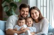 © Leo Rohmann - Heartwarming family portrait of parents with their two children symbolizing love care and affection in a soft natural setting with gentle warm lighting