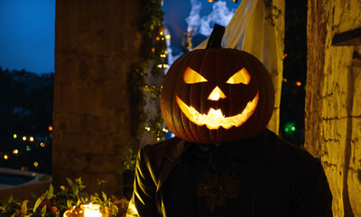 man with halloween jack o lantern with pumpkin on head instead of head