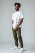 © Alex - Casual Male Model Posing in Oversized White T-Shirt and Olive Green Chinos, Full Body Shot Generative AI