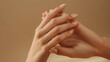 © Kinza - Beautiful Woman Hands. Spa and Manicure concept. Female hands with french manicure. Soft skin, skincare concept. Beauty nails. over beige background