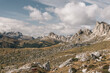 © Amparo Garcia - Dolomite mountain range seen from a rocky high altitude plateau, with dramatic clouds overhead