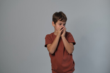 Wall Mural - Boy in casual attire impersonates a wild creature, eyes popped and roaring. Reminds viewers of the uninhibited spirit of childhood and the universality of Youngster dramatizes a scare.