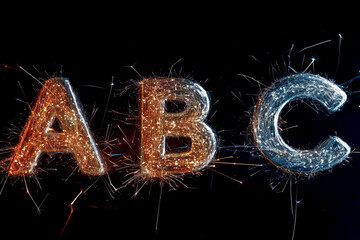 The letters A, B, and C, as sparks and isolated on black.