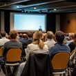 © Tadeusz - Focused audience at a professional conference, engaged in a presentation