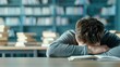 © Anna - Student sleeping on book in library surrounded by stacked books