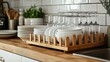 © ArtCookStudio - Organized kitchen countertop displaying stacks of clean dishes and glassware in a sunny setting