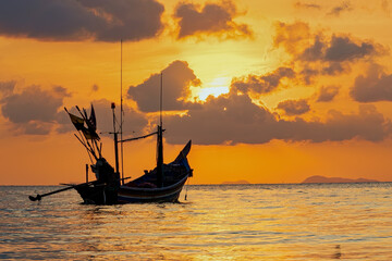 Long Tail boat of fishermen at sunset in Koh Phangan, Thailand