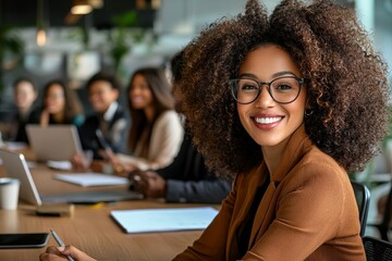 Poster - Leading a group of colleagues in an office boardroom is a black businesswoman
