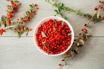 Wall Mural - fresh ripe red goji berries in a bowl on a wooden table