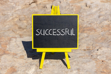 Successful symbol. Concept word Successful on beautiful chalk blackboard. Beautiful red stone background. Business successful concept. Copy space.