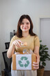 © wichayada - Young Woman Sorting Plastic Bottles for Recycling at Home to Promote Environmental Sustainability and Waste Reduction