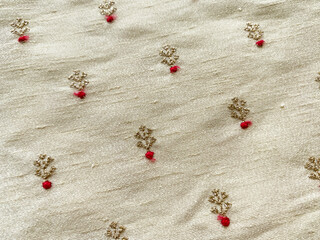 Intricate golden thread small floral embroidered butti with red resham dot on beige raw silk fabric