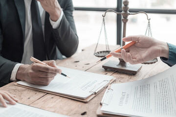 male lawyer working with contract documents and wooden hammer on table in courtroom justice and law 