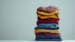 © Pixcellence - Neatly Folded Clothes Stacked on a Table