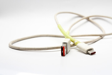 USB cable type C tangled over white isolated background