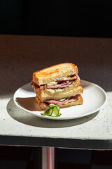 Wall Mural - Portion of gourmet sandwich with pickles on the cafe table