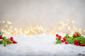 Wall Mural - christmas holiday background with snow, fir tree and decorations with christmas light behind.