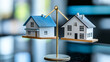 © Quality One   - Two model houses balanced on scale illustrate concept of comparison and value in real estate. image conveys sense of balance and decision making in housing choices
