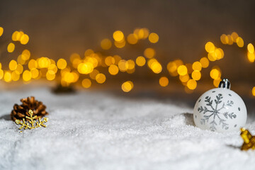 Wall Mural - christmas holiday background with snow, fir tree and decorations with christmas light behind. christ
