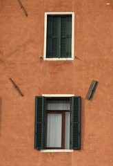 Decorative wooden window on an old building in Italy