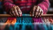 ©  Jovaduplex - A pair of elderly hands skillfully weave vibrant, colorful fabric, symbolizing cultural tradition, craftsmanship, and the colorful tapestry of human creativity and emotion.
