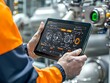 © Prim2513 - A technician interacts with a high-tech tablet displaying control systems in an industrial setting, highlighting advanced technology in operation.
