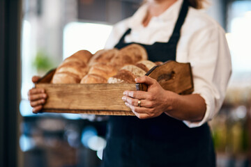 Canvas Print - Bakery, box and hands of baker with bread in cafe for serving food, products and pastry for small business. Restaurant, shop and person for service, help and baked goods for hospitality in store