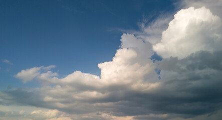 a beautiful sky filled with fluffy white clouds and deep blue accents, perfect for backgrounds, land