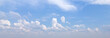 © daily_creativity - A serene view of a clear blue sky adorned with fluffy white clouds, creating a peaceful atmosphere ideal for backgrounds and nature-themed projects.
