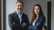© M.Daim - Photo of smiling businesswoman and business leader standing looking at camera while working.