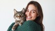 © Aneeta - Photo of a woman in a green sweater holding a cat.