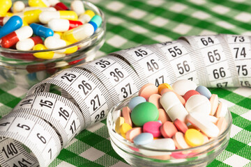 Wall Mural - medical weight loss pills of different colors and measuring tape