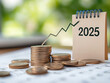 © BOTAHRY DEX - 2025 desk calendar and stack of coins with arrow rising. The concept of business growth, Financial investment, Market stock, Profit return, Dividend and Business fund in year 2025