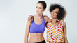 © peopleimages.com - Happy women, fitness and hug with space for exercise, training or workout together on a studio background. Young, female person or friends with smile, sportswear or fashion for health and wellness