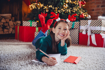 Wall Mural - Full body photo of nice little girl lying floor write letter wear christmas clothes enjoy cozy x-mas party decoration interior flat indoors