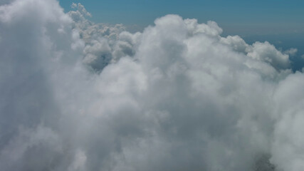 Wall Mural - flying through white fluffy clouds