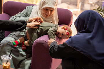 Joyful Family Gathering with Playful Child and Women