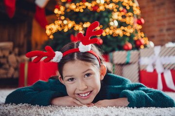 Sticker - Full body photo of nice little girl dreamy lying floor wear green christmas clothes enjoy cozy x-mas party decoration interior flat indoors