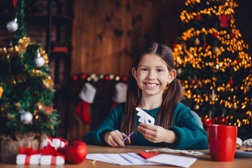 Sticker - Photo of nice little girl cutting snowflakes wear green christmas clothes enjoy cozy x-mas party decoration interior flat indoors