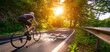 © AA+W - New year 2025 or start straight and beginning concept. Man ride on bike and the number 2025 start written on the road at sunset with lens flare. Concept of challenge or career path, business strategy.